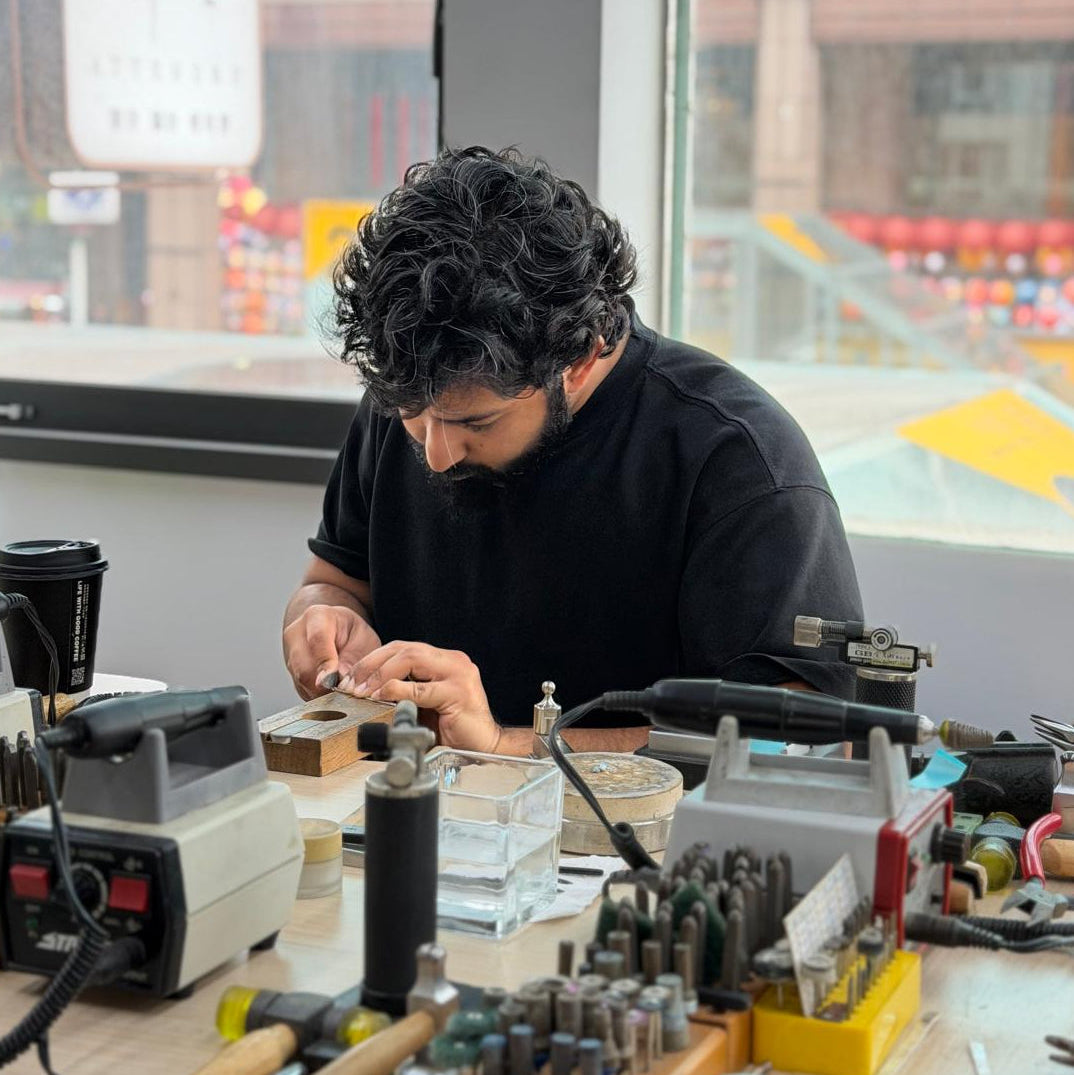 Person working on a project with tools and equipment in a workshop setting.
